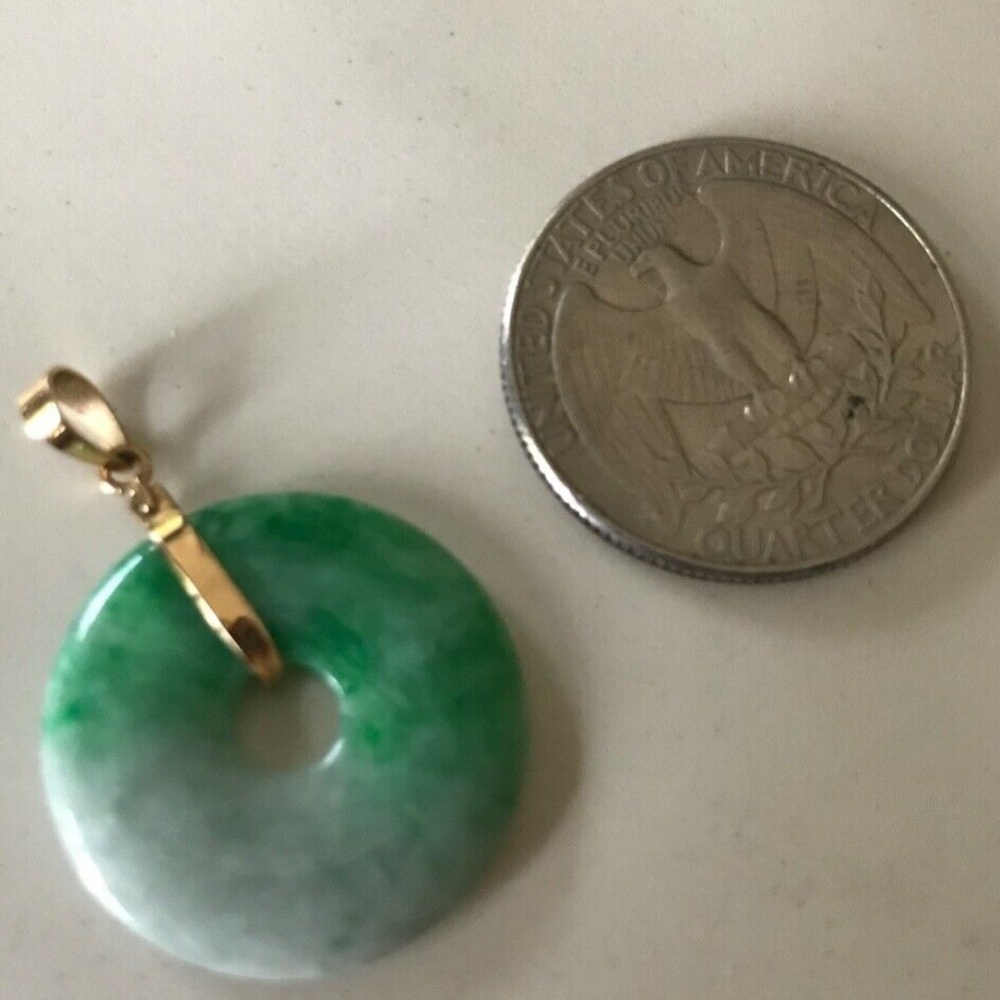 Beautiful light green jade and gold circle pendant.